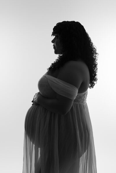 A black and white photo of a pregnant woman.