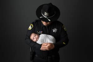 A police officer holding a baby.