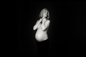 A black and white photo of a pregnant woman.