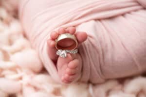 A baby's foot with a ring on it.