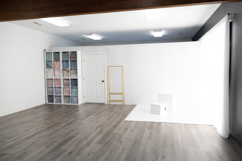 Minimalist studio interior with storage and props.