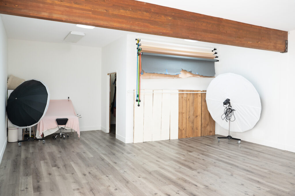 Empty photography studio with lights and equipment.